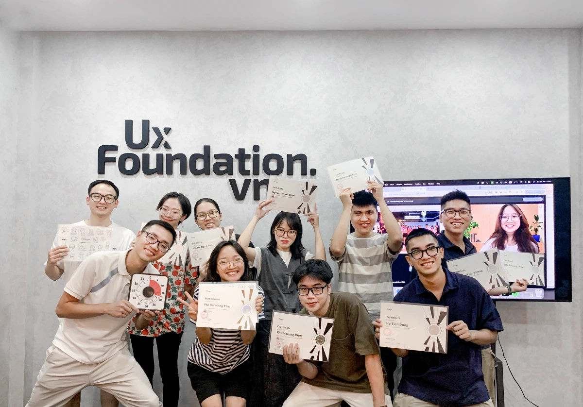 It&rsquo;s me, wearing a gray striped tee literally holding my certificate in front of the camera